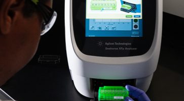 A scientist works with the Seahorse XFp Analyzer by Agilent Technologies.